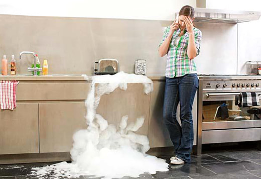 Woman with overflowing sink calling plumber